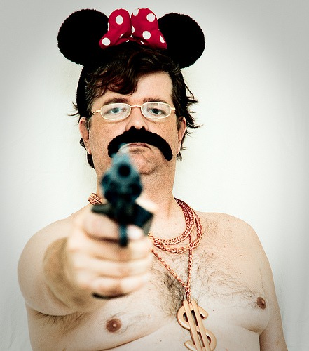 About a Man, a Mouse, a Gun, a Moustache, Some Gold Chains, a Pair of Glasses, and a Polkadot Bow...